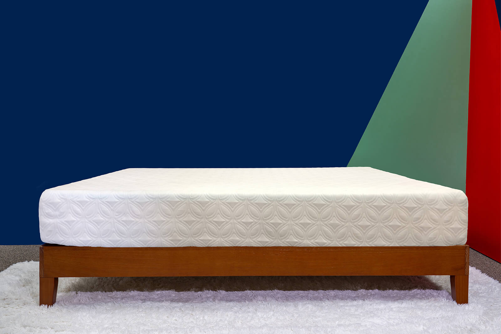 Photo of the Cocoon Essential Mattress on a bedframe in a bedroom taken from a side angle