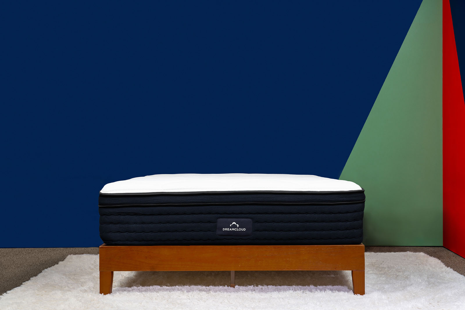 distant view of the DreamCloud Premier mattress on a bed frame in a bedroom