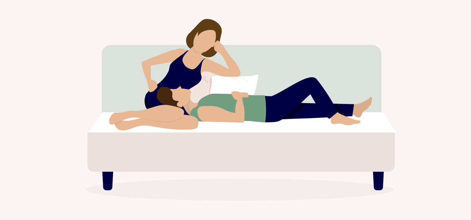 Lap Pillow cuddle position where a couple is on a couch and one partner is sitting up while the other is laying horizontally using their partner's lap as a pillow