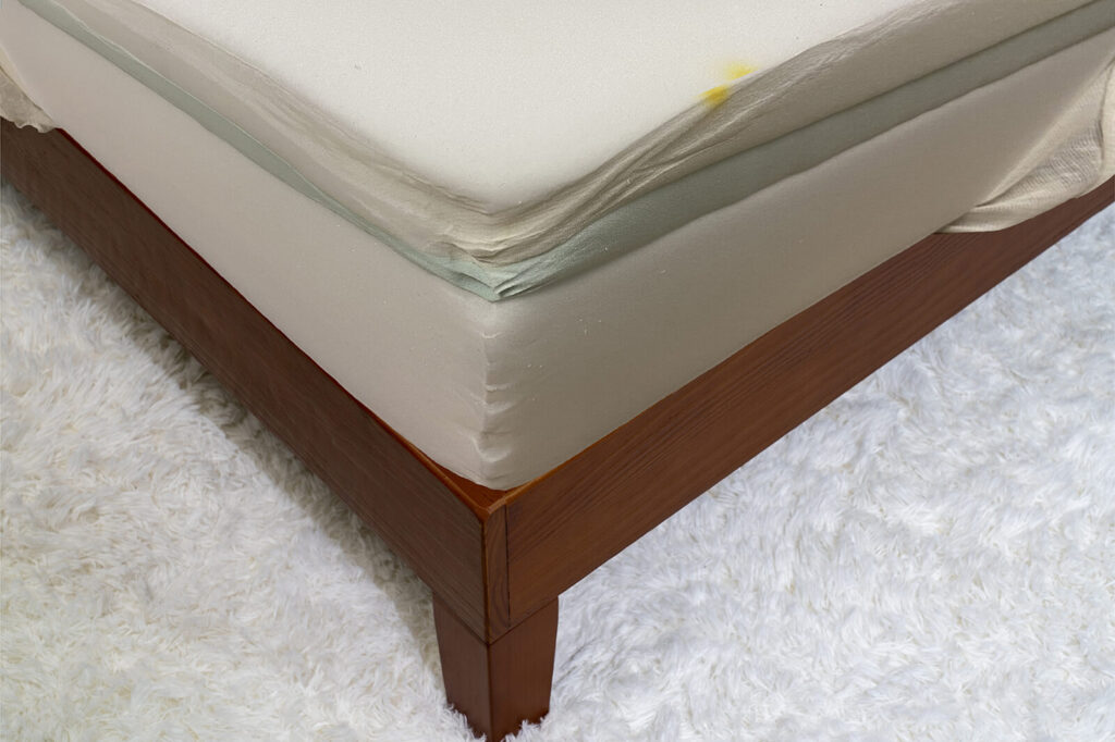 Close up photo of the inside of the Nectar Mattress on a bedframe in a bedroom taken from a corner angle