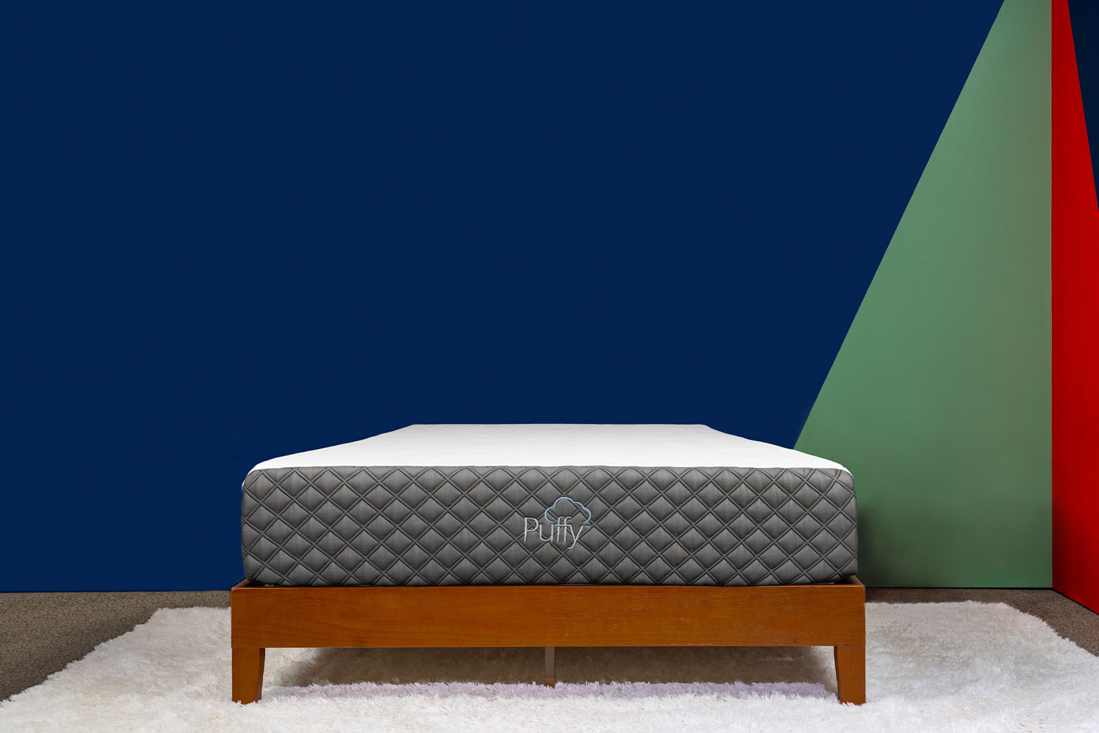 Front angle photo of a Puffy Lux mattress on a bed