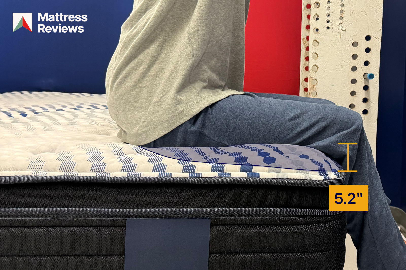 photo of a mannequin sitting on the edge of the mattress showing a displacement of 52