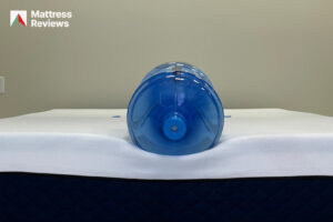 Photo of a water jug sitting on the edge of the Silk Snow mattress to demonstrate edge support