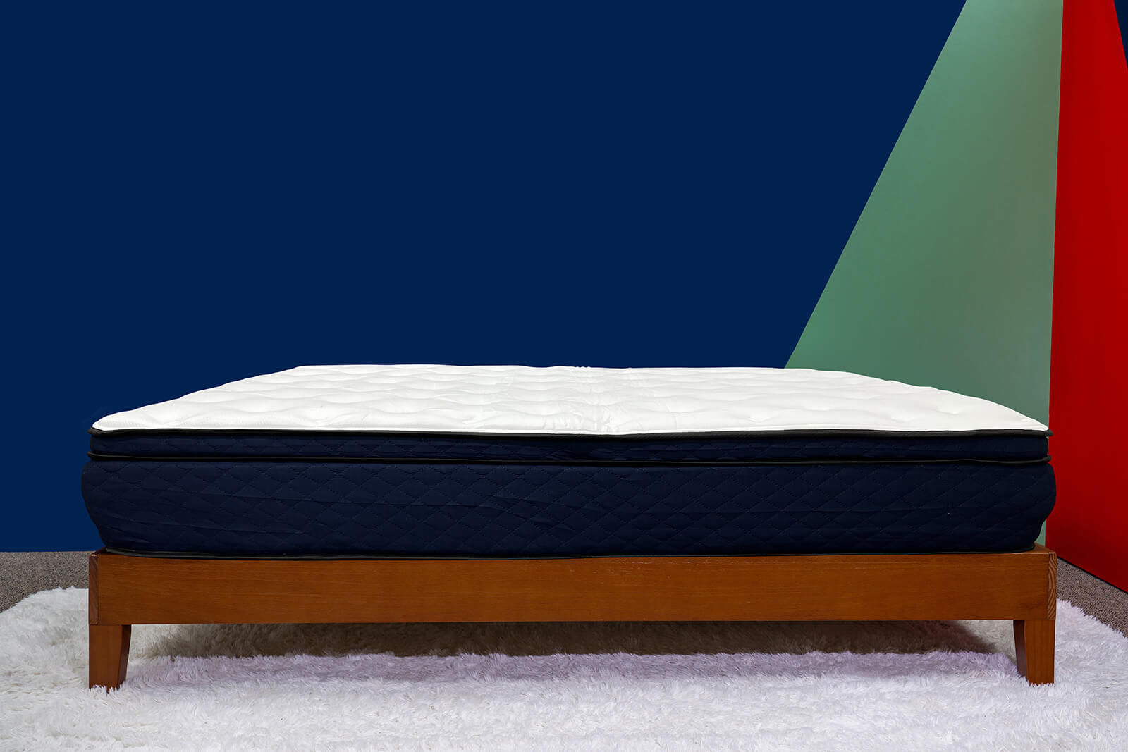 A photo of the Silk Snow Hybrid mattress sitting on a bed frame