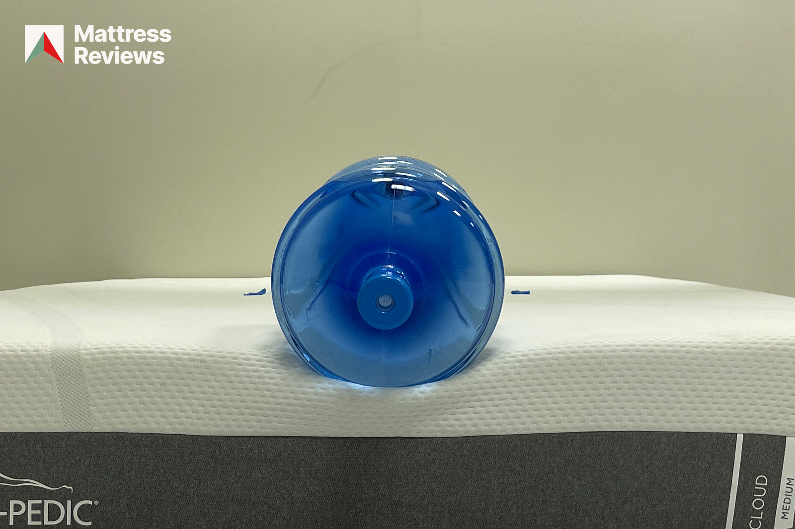 Photo of a water jug sitting on the edge of the TempurPedic Cloud mattress to demonstrate edge support