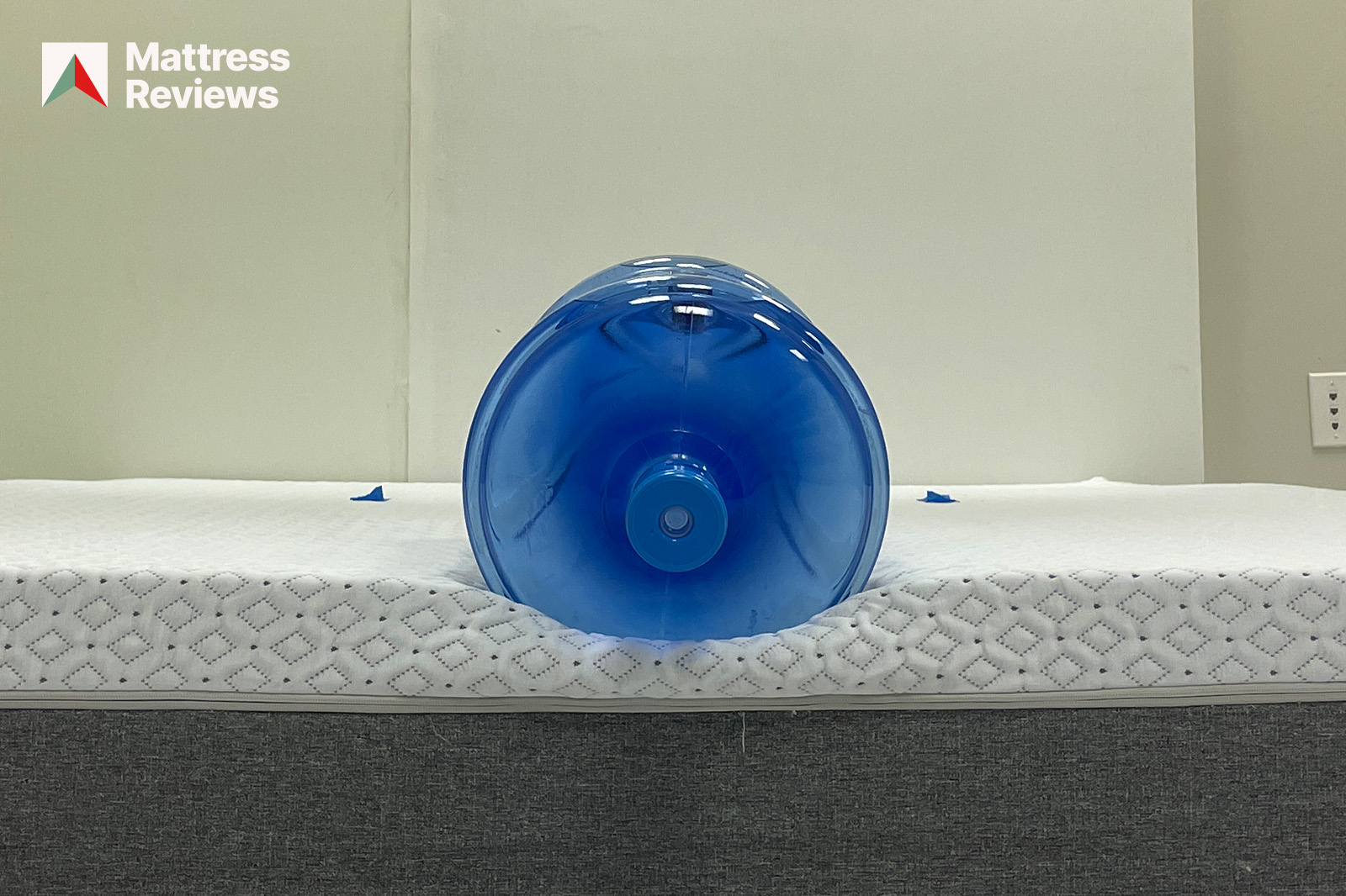 Photo of a water jug sitting on the edge of the Endy mattress to demonstrate edge support
